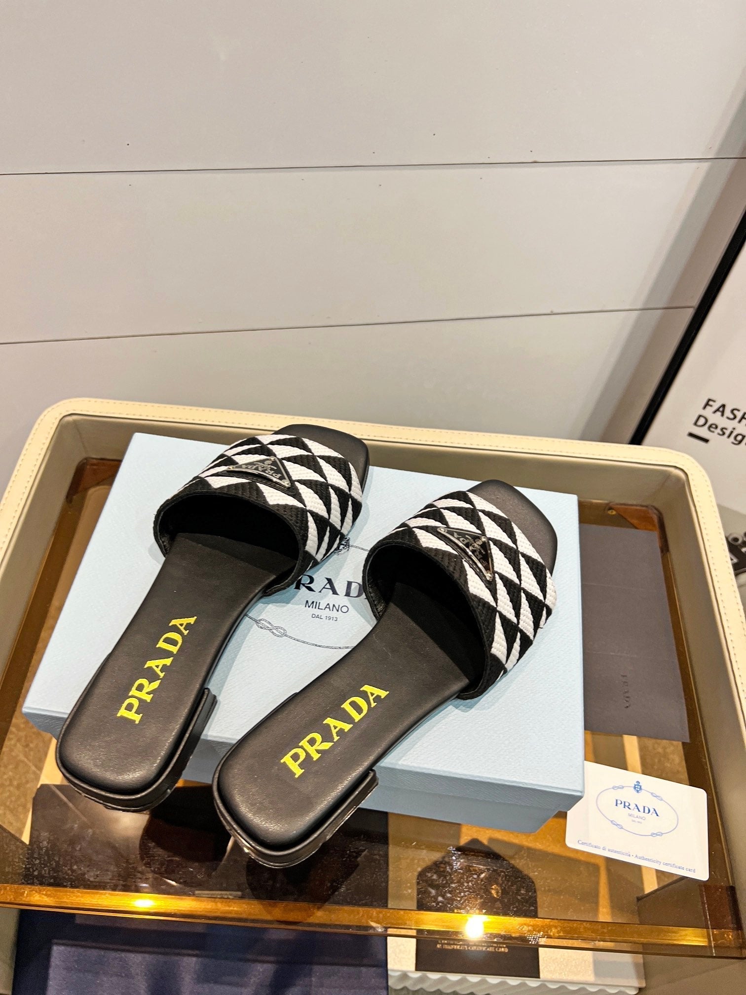 PRADA EMBROIDERED SLIDES FLAT BLACK AND WHITE FABRIC