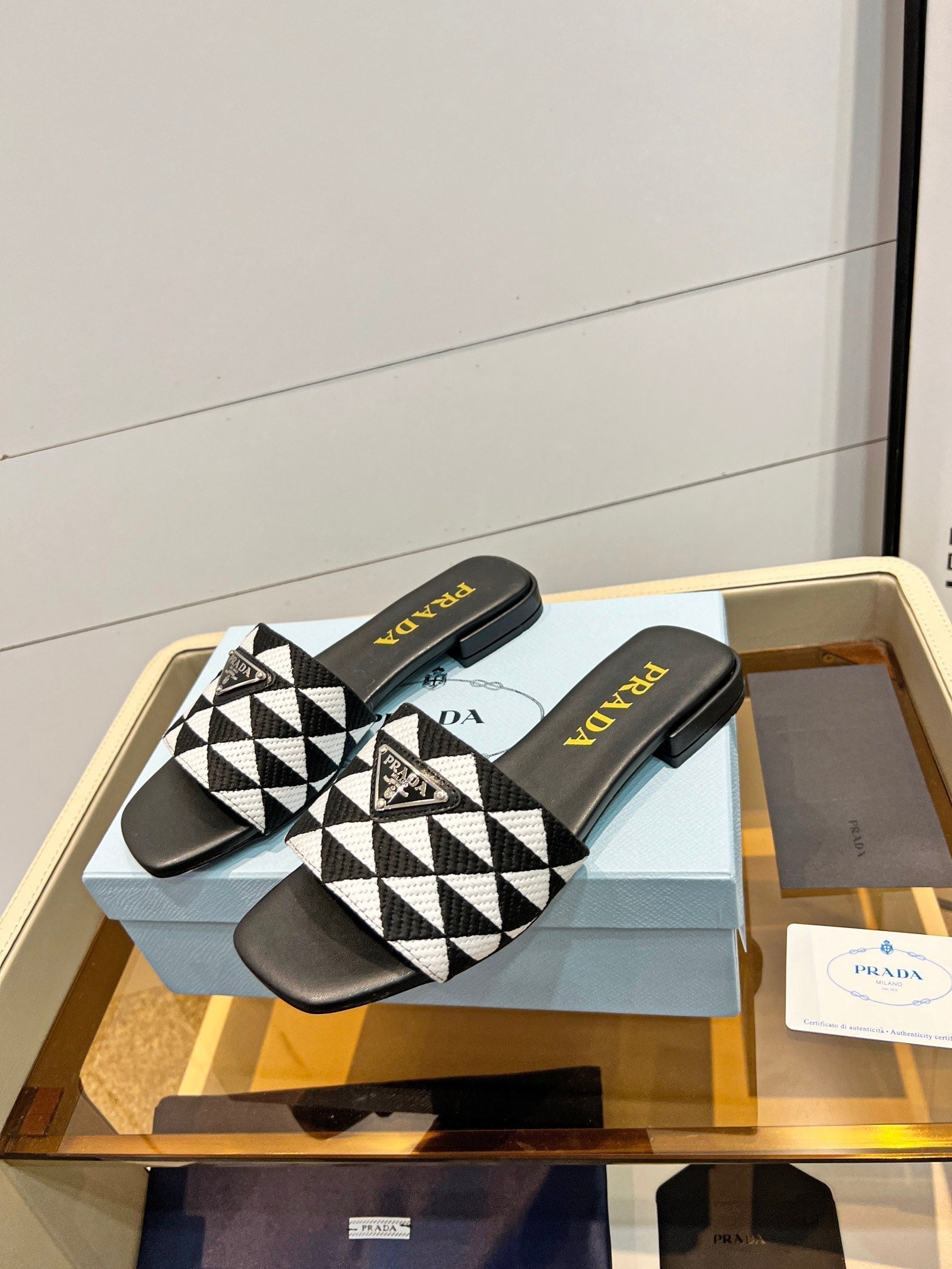 PRADA EMBROIDERED SLIDES FLAT BLACK AND WHITE FABRIC