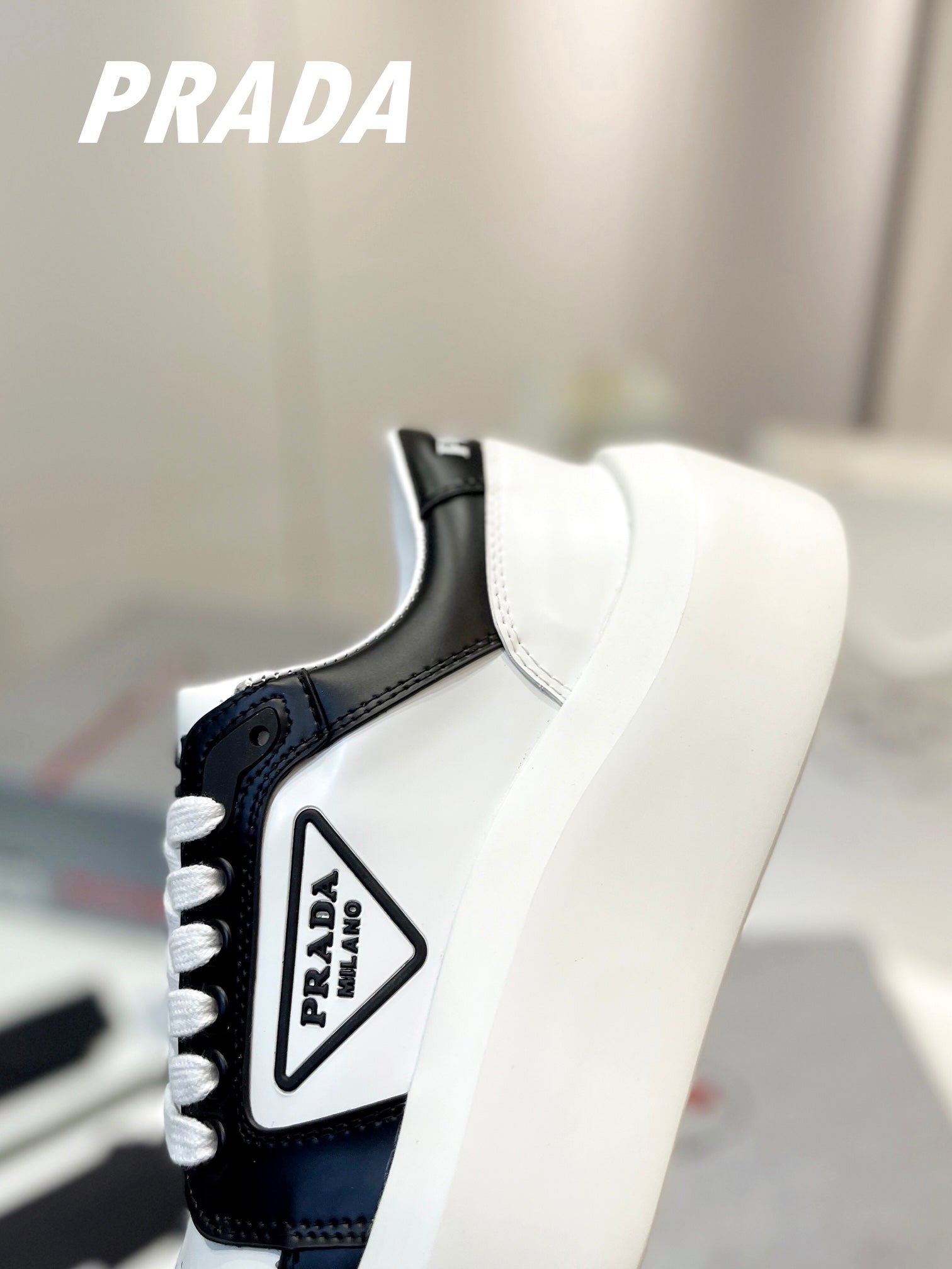 PRADA DOWNTOWN THICK-SOLE SNEAKERS BLACK AND WHITE CALFSKIN