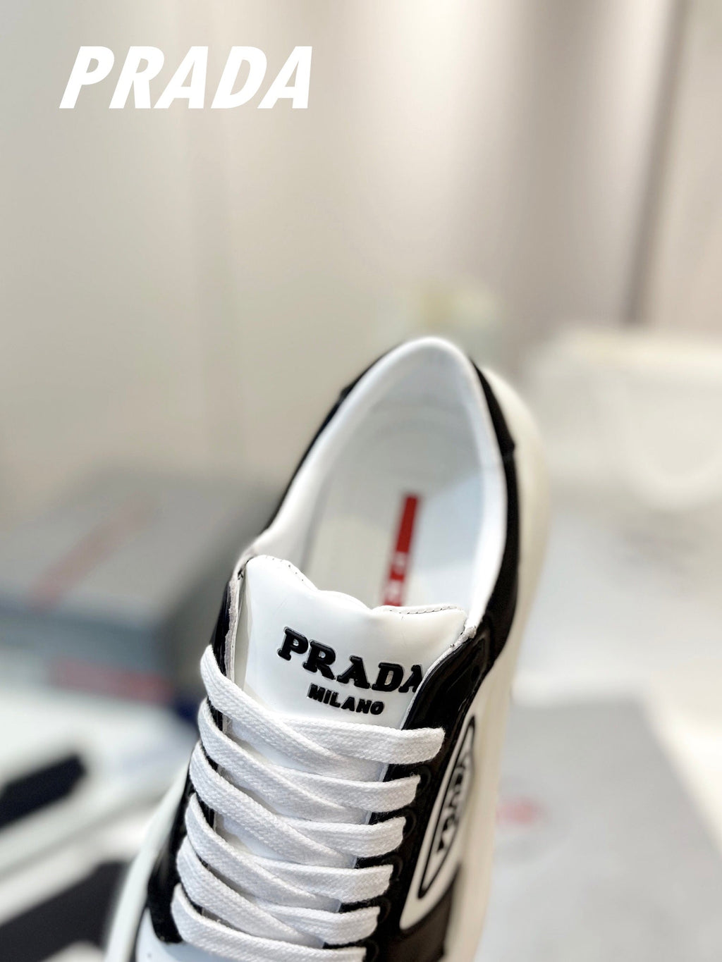 PRADA DOWNTOWN THICK-SOLE SNEAKERS BLACK AND WHITE CALFSKIN