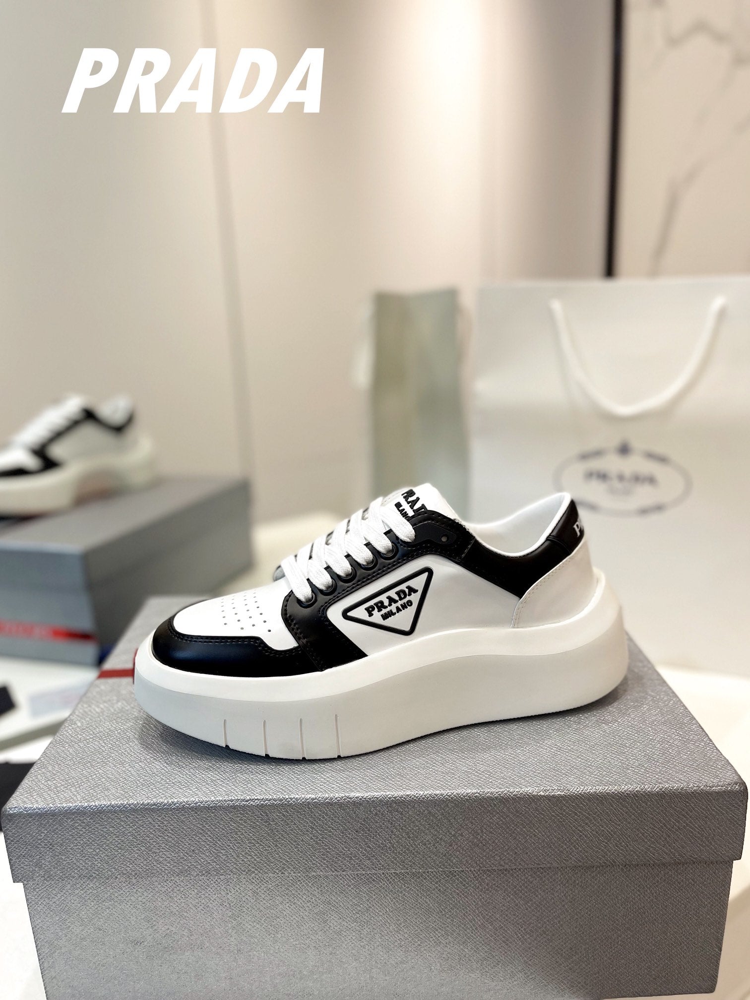 PRADA DOWNTOWN THICK-SOLE SNEAKERS BLACK AND WHITE CALFSKIN