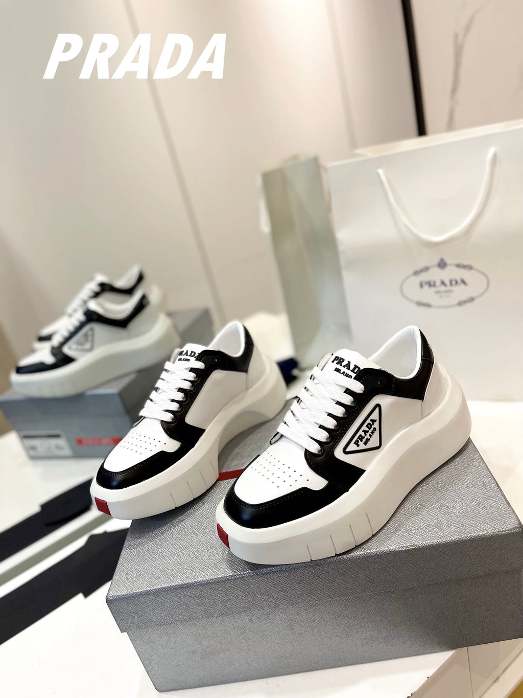 PRADA DOWNTOWN THICK-SOLE SNEAKERS BLACK AND WHITE CALFSKIN