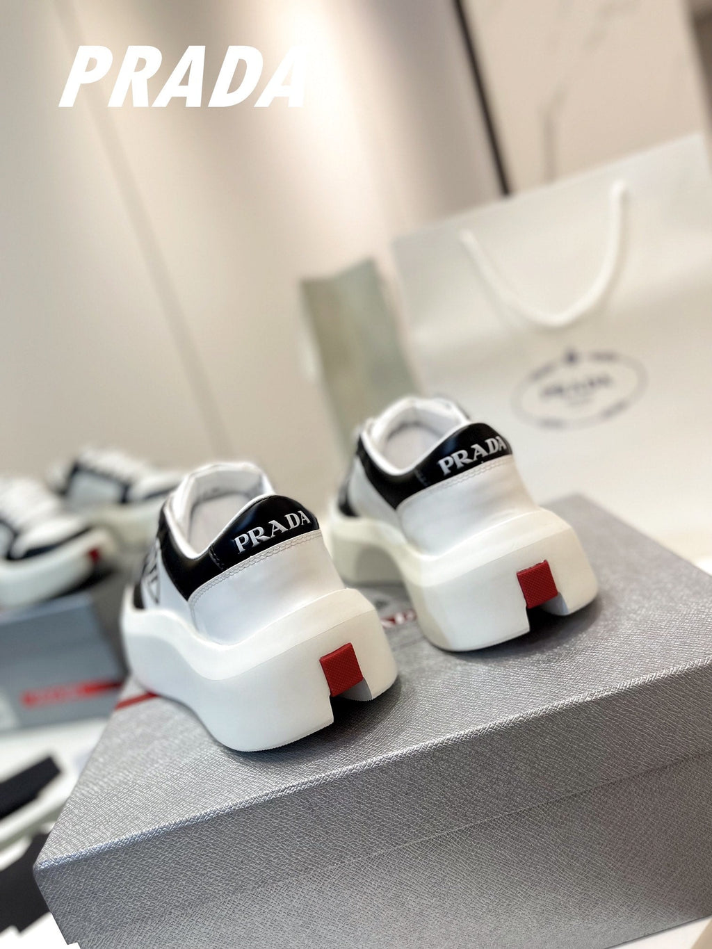 PRADA DOWNTOWN THICK-SOLE SNEAKERS BLACK AND WHITE CALFSKIN
