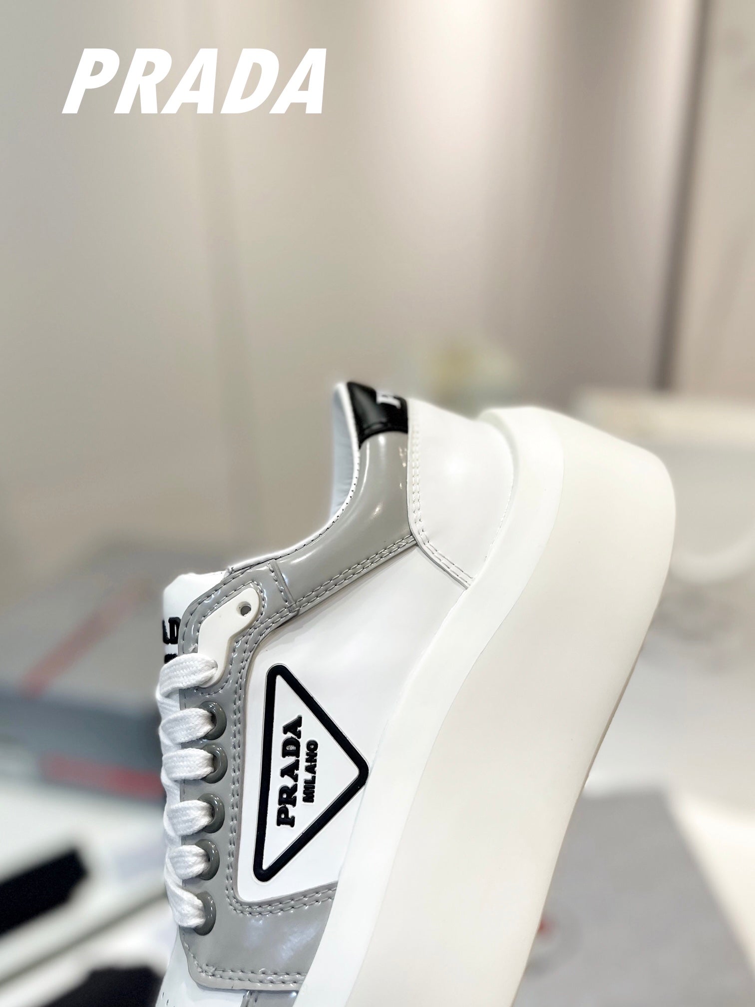 PRADA DOWNTOWN THICK-SOLE SNEAKERS WHITE AND GRAY CALFSKIN