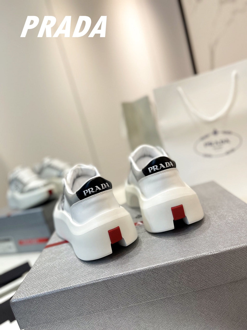 PRADA DOWNTOWN THICK-SOLE SNEAKERS WHITE AND GRAY CALFSKIN