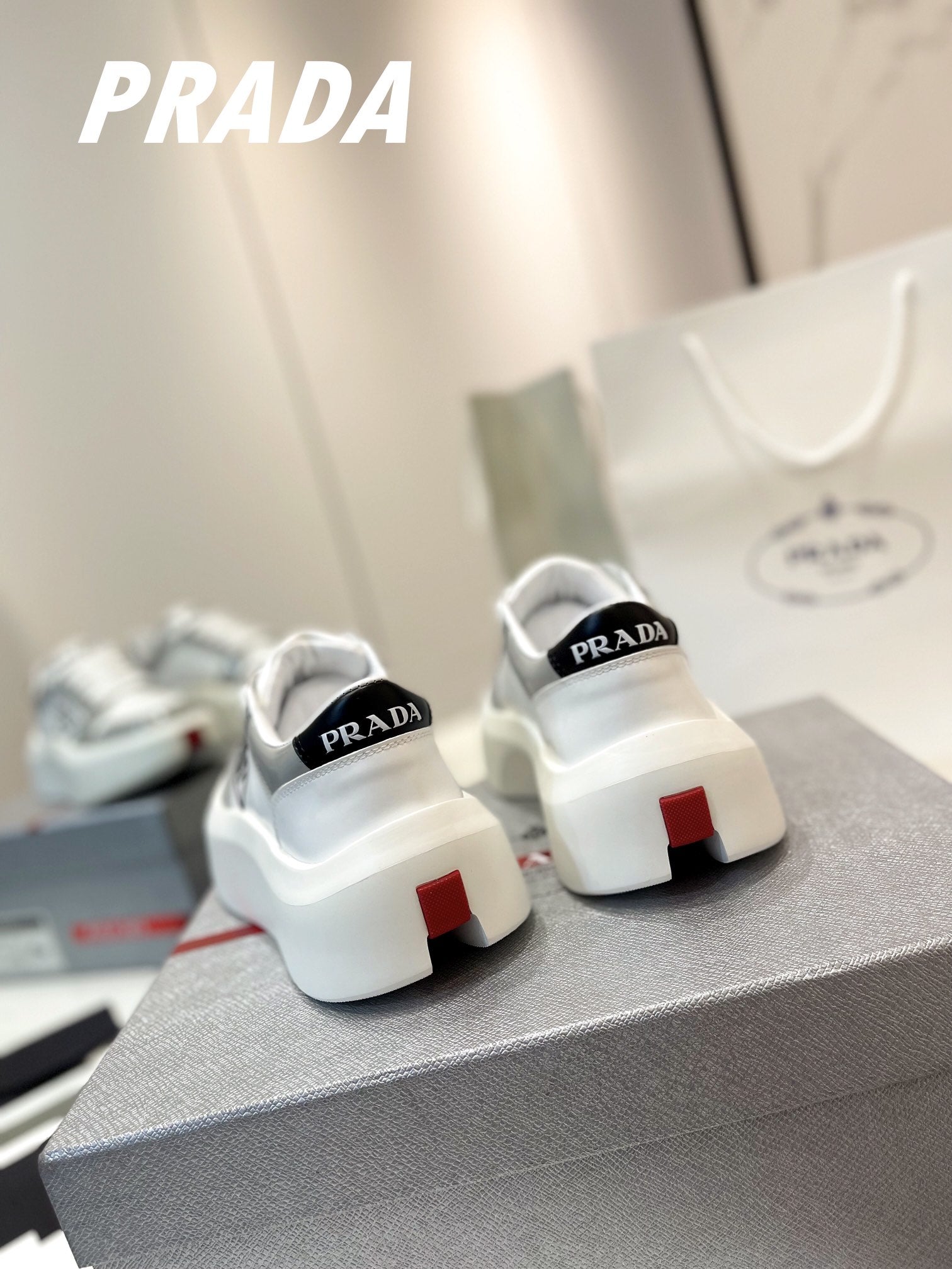 PRADA DOWNTOWN THICK-SOLE SNEAKERS WHITE AND GRAY CALFSKIN