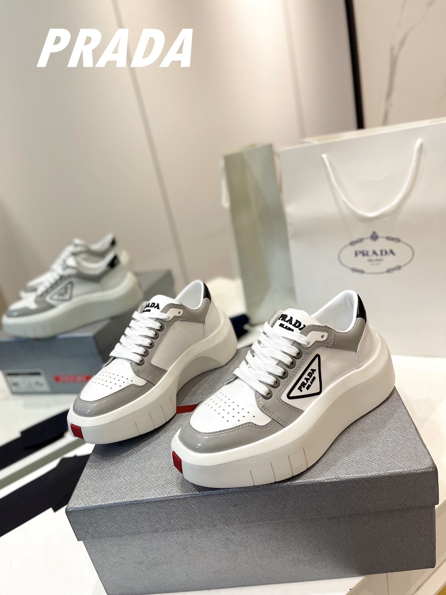 PRADA DOWNTOWN THICK-SOLE SNEAKERS WHITE AND GRAY CALFSKIN
