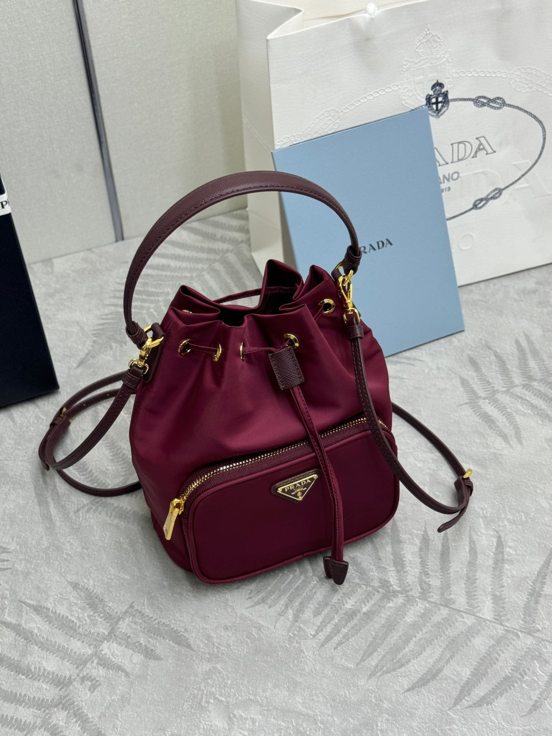 PRADA 25S DUET BUCKET BAG 23 IN BURGUNDY RE-NYLON GOLD HARDWRE