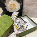 GUCCI HAIRBAND IN WHITE FLORAL FABRIC 385855