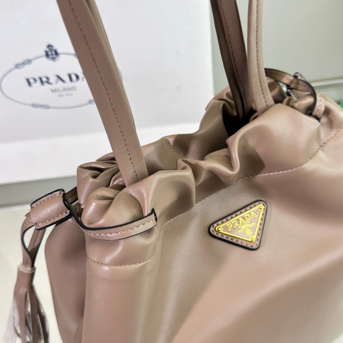 PRADA DRAWSTRING BUCKET BAG 25 IN BROWN BEAR SOFT LAMBSKIN