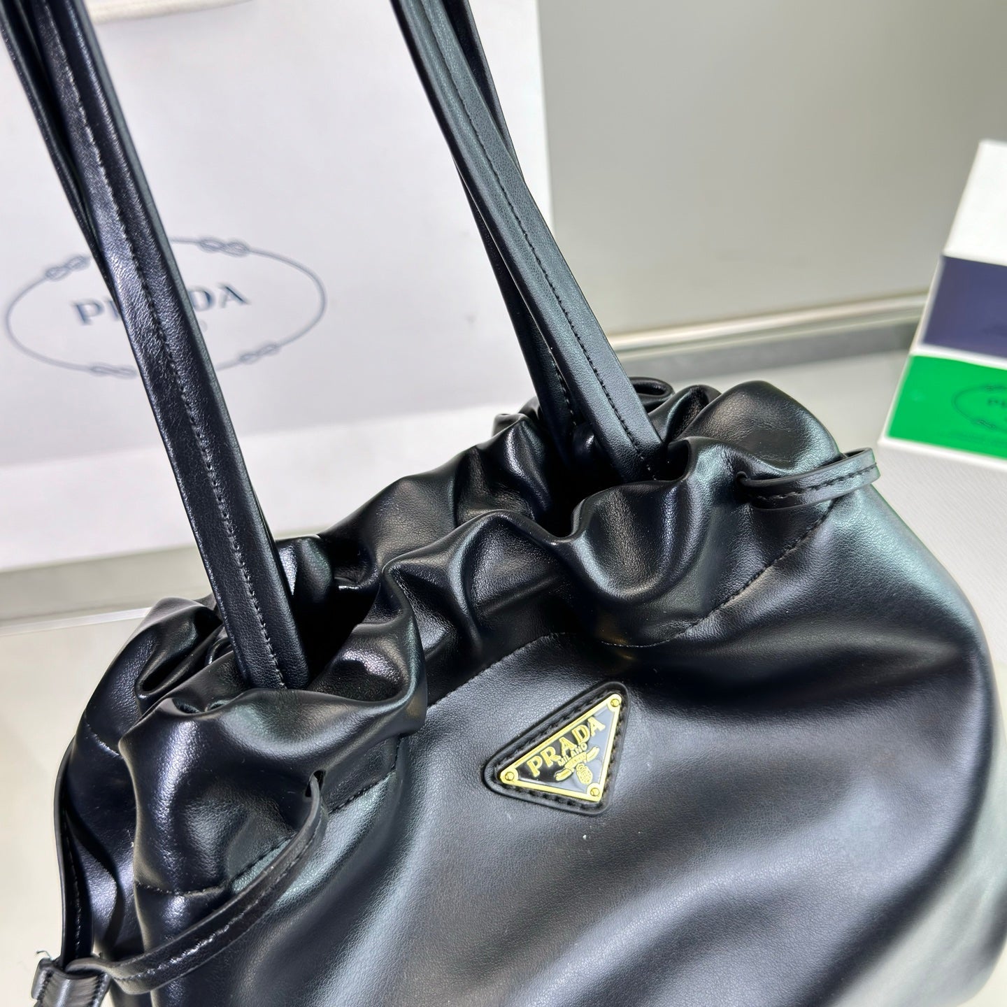 PRADA DRAWSTRING BUCKET BAG 25 IN BLACK SOFT LAMBSKIN