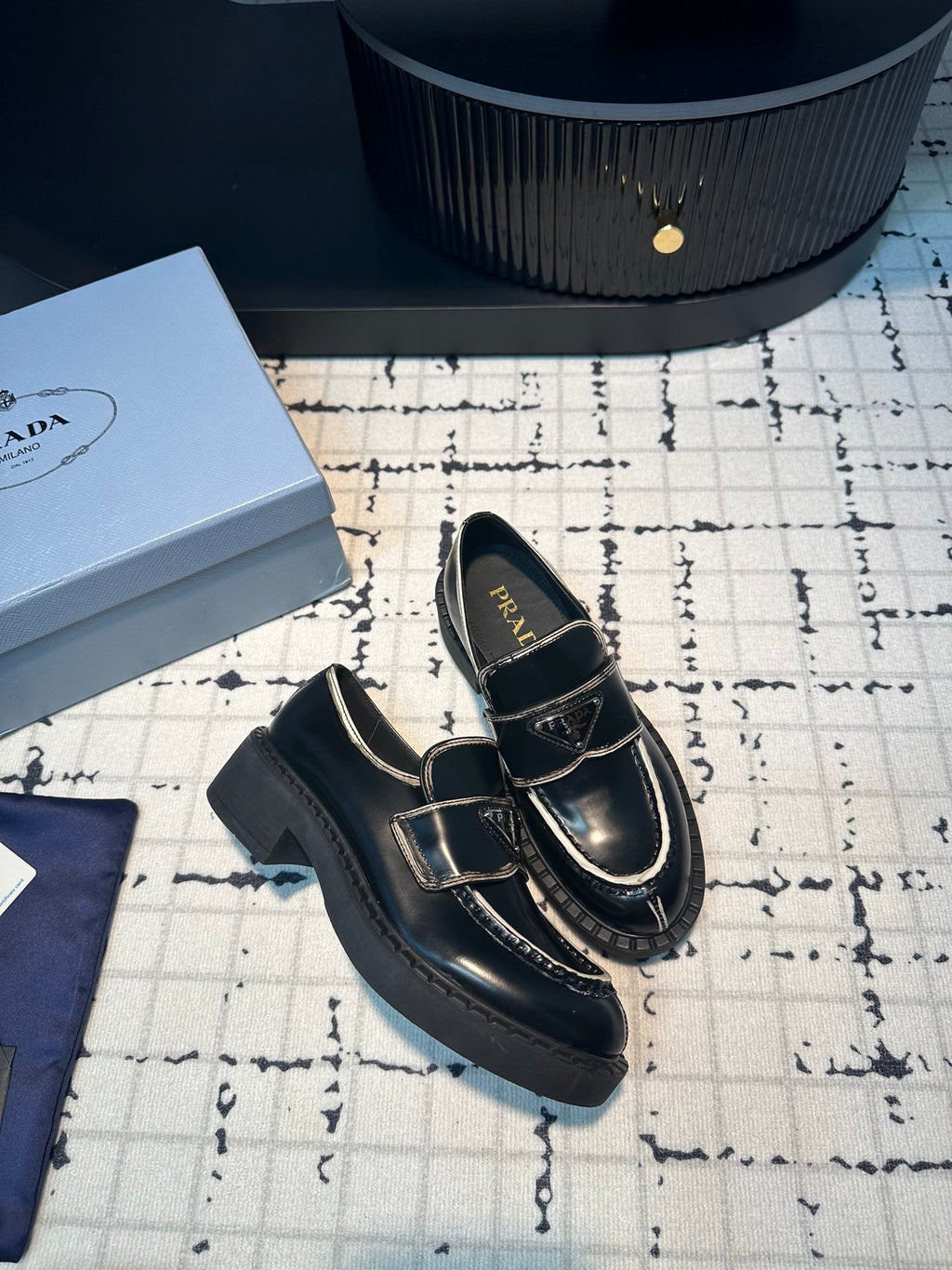 PRADA SCHOCOLATE BRUSHED LOAFERS BLACK AND WHITE BORDER CALFSKIN