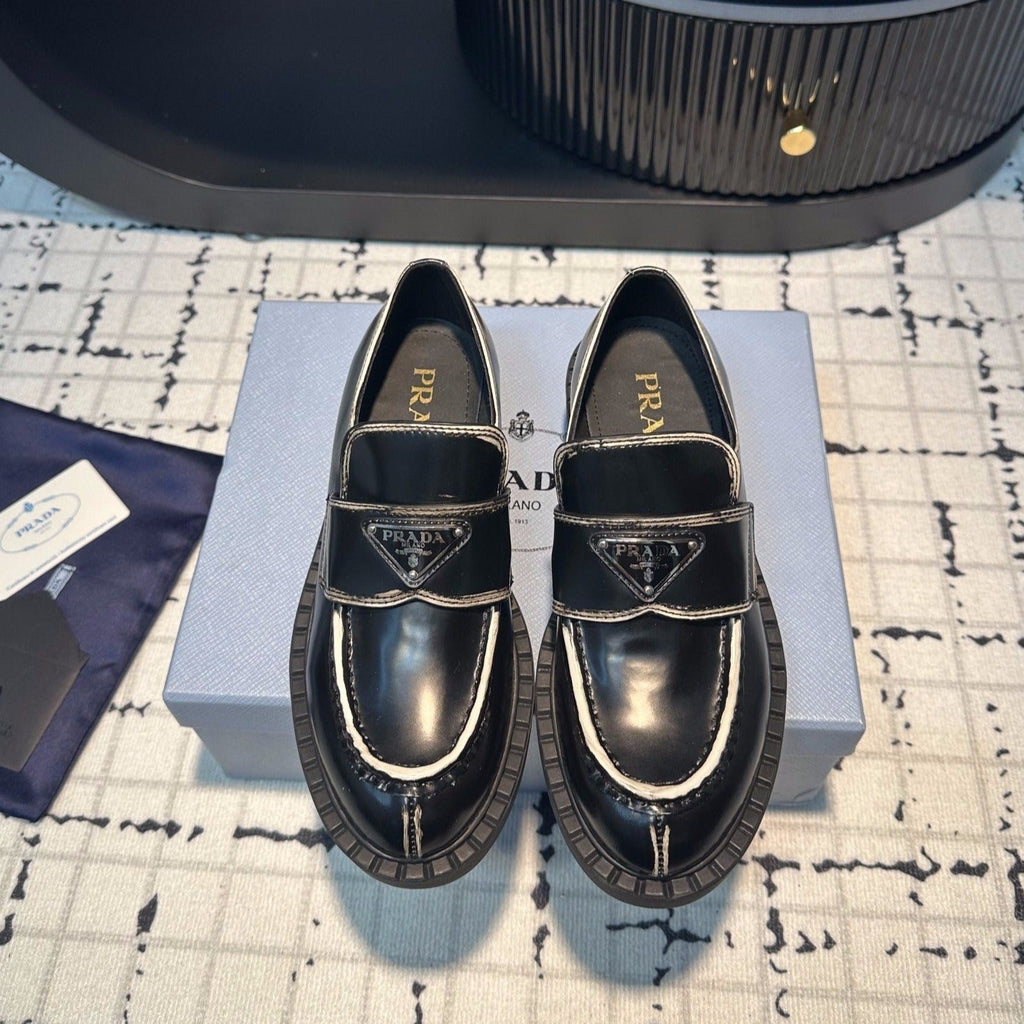 PRADA SCHOCOLATE BRUSHED LOAFERS BLACK AND WHITE BORDER CALFSKIN