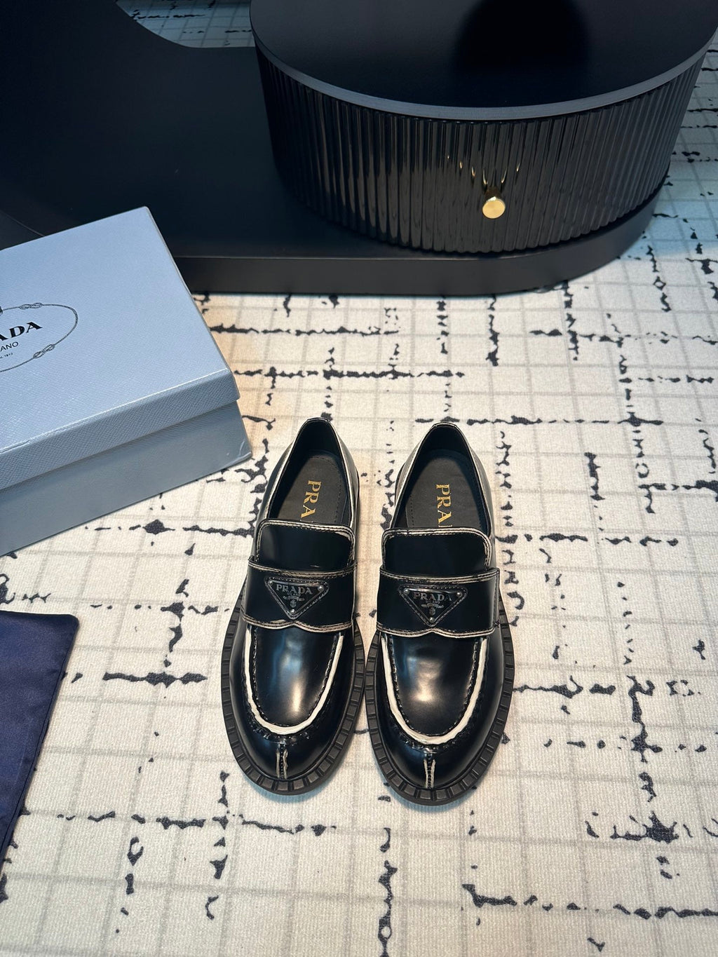 PRADA SCHOCOLATE BRUSHED LOAFERS BLACK AND WHITE BORDER CALFSKIN