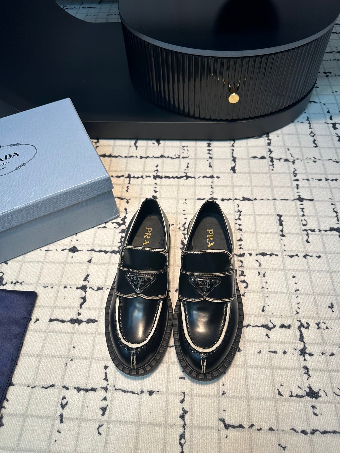 PRADA SCHOCOLATE BRUSHED LOAFERS BLACK AND WHITE BORDER CALFSKIN