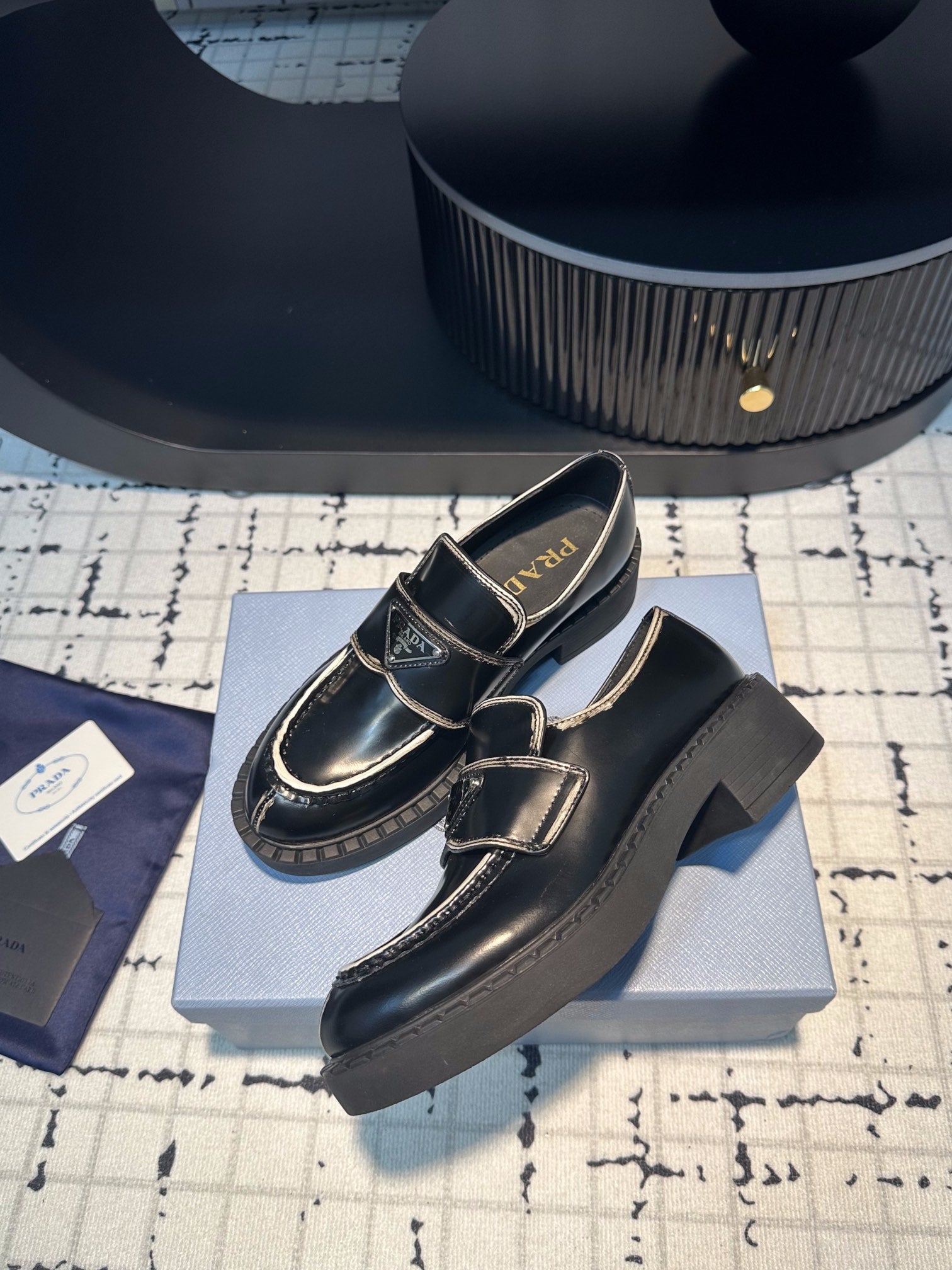 PRADA SCHOCOLATE BRUSHED LOAFERS BLACK AND WHITE BORDER CALFSKIN