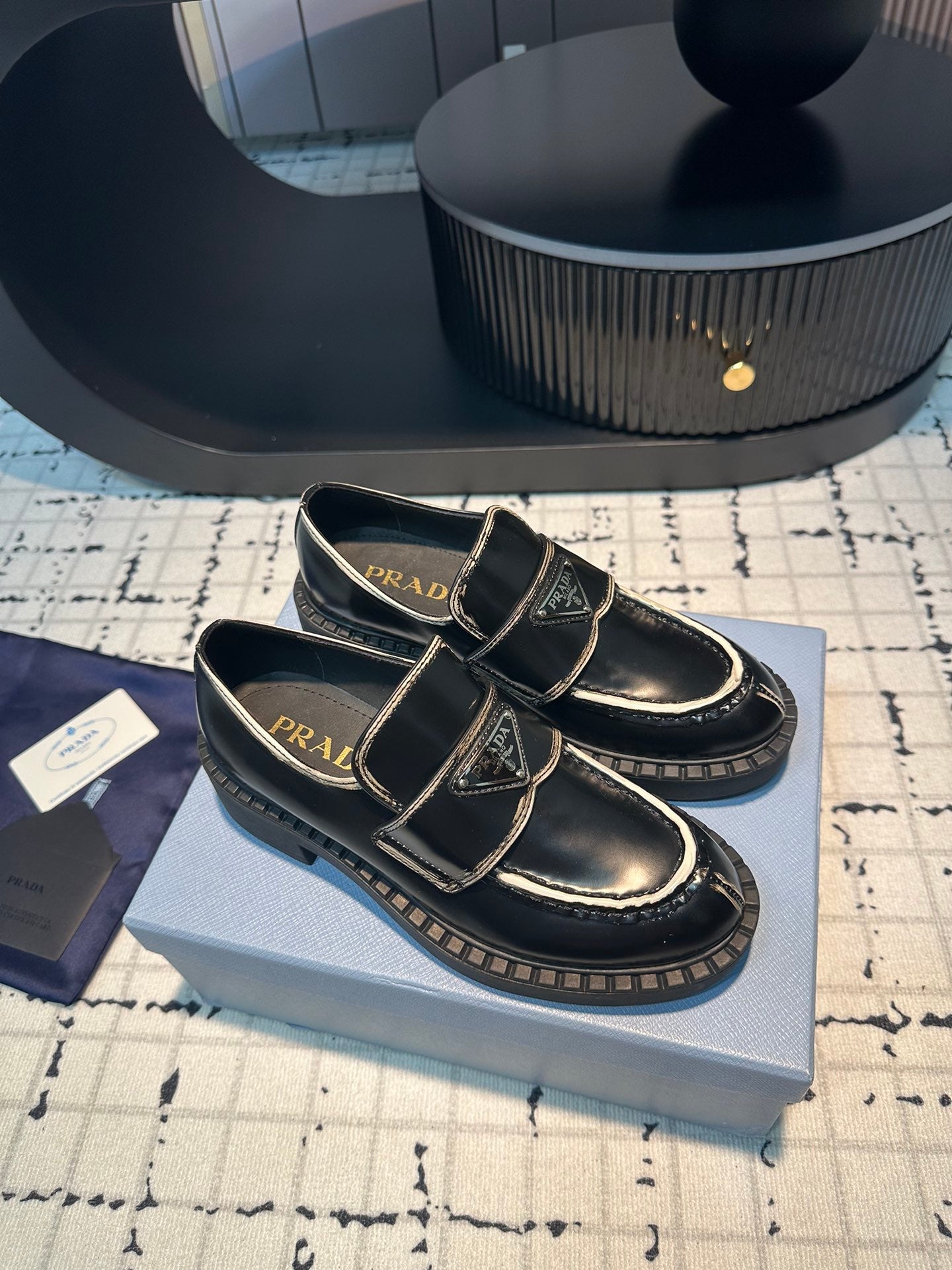 PRADA SCHOCOLATE BRUSHED LOAFERS BLACK AND WHITE BORDER CALFSKIN