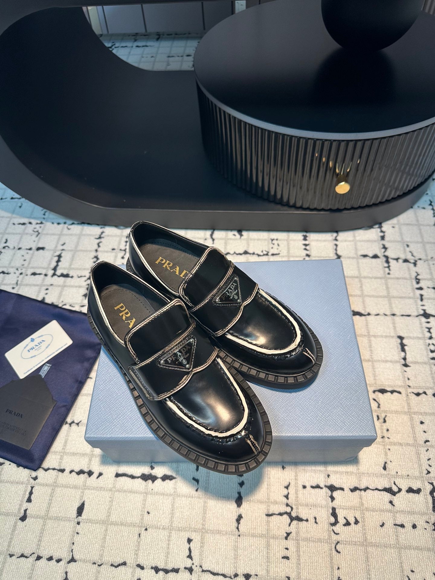 PRADA SCHOCOLATE BRUSHED LOAFERS BLACK AND WHITE BORDER CALFSKIN