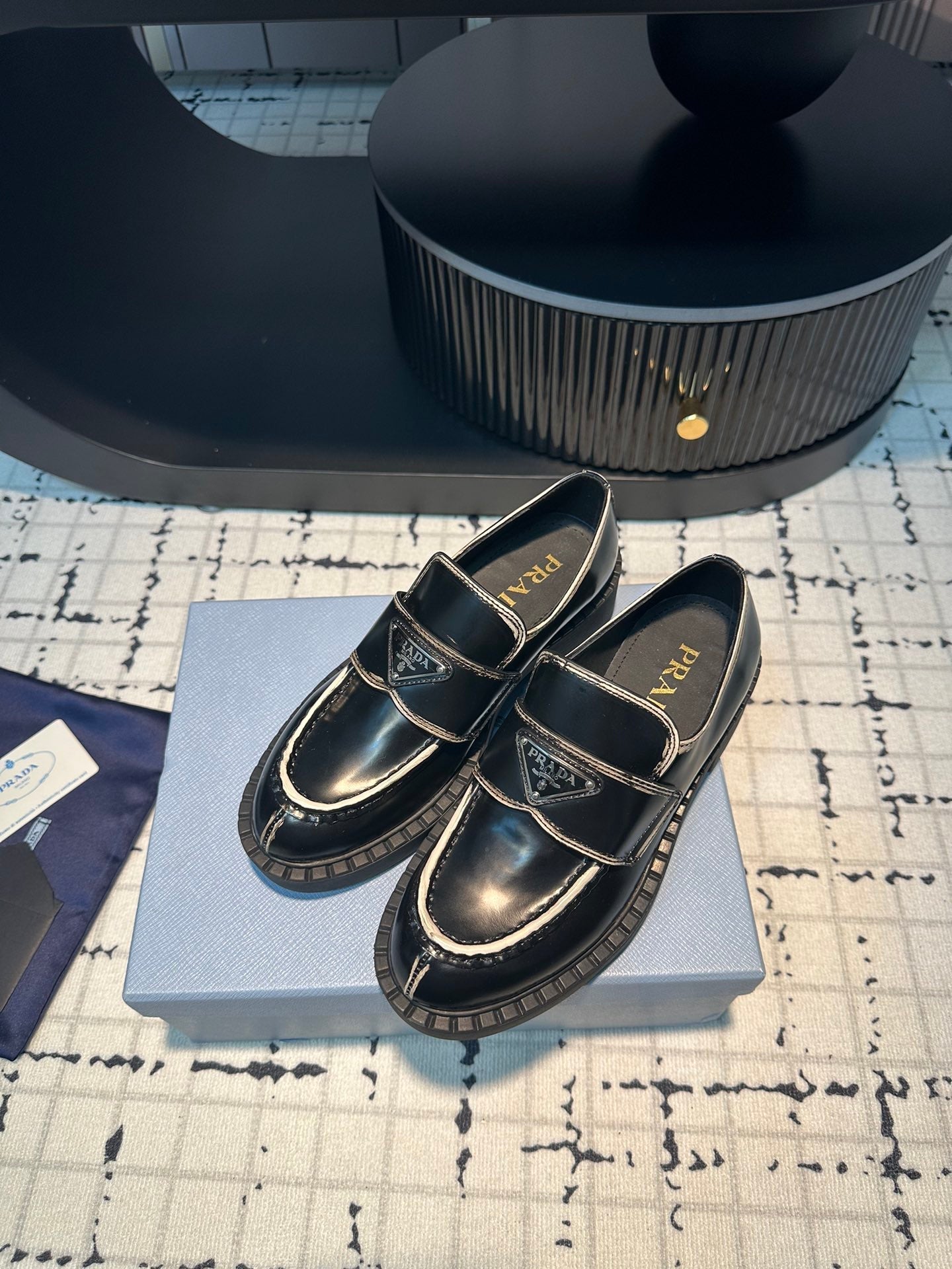 PRADA SCHOCOLATE BRUSHED LOAFERS BLACK AND WHITE BORDER CALFSKIN