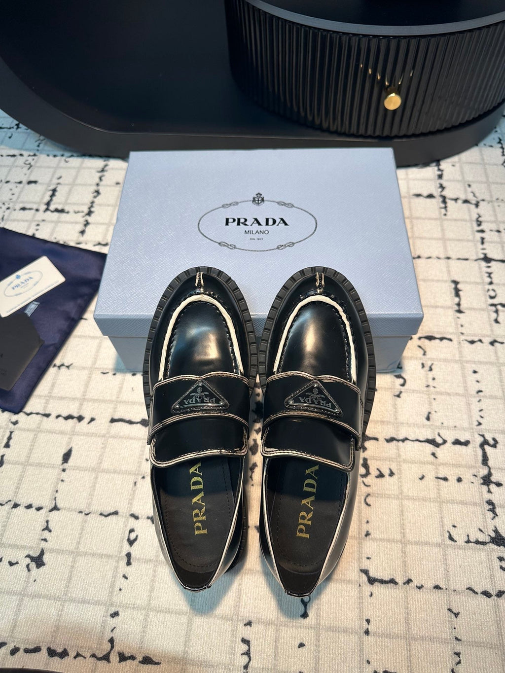 PRADA SCHOCOLATE BRUSHED LOAFERS BLACK AND WHITE BORDER CALFSKIN