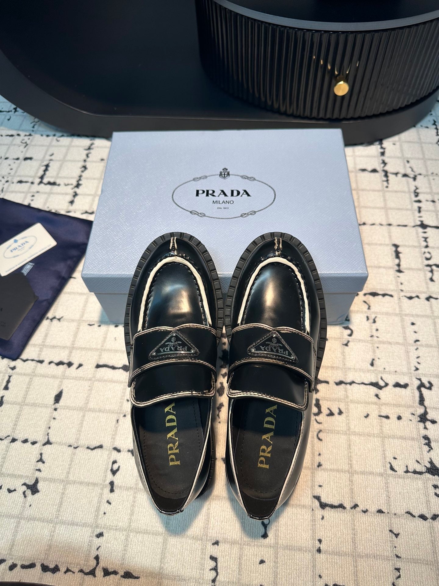PRADA SCHOCOLATE BRUSHED LOAFERS BLACK AND WHITE BORDER CALFSKIN