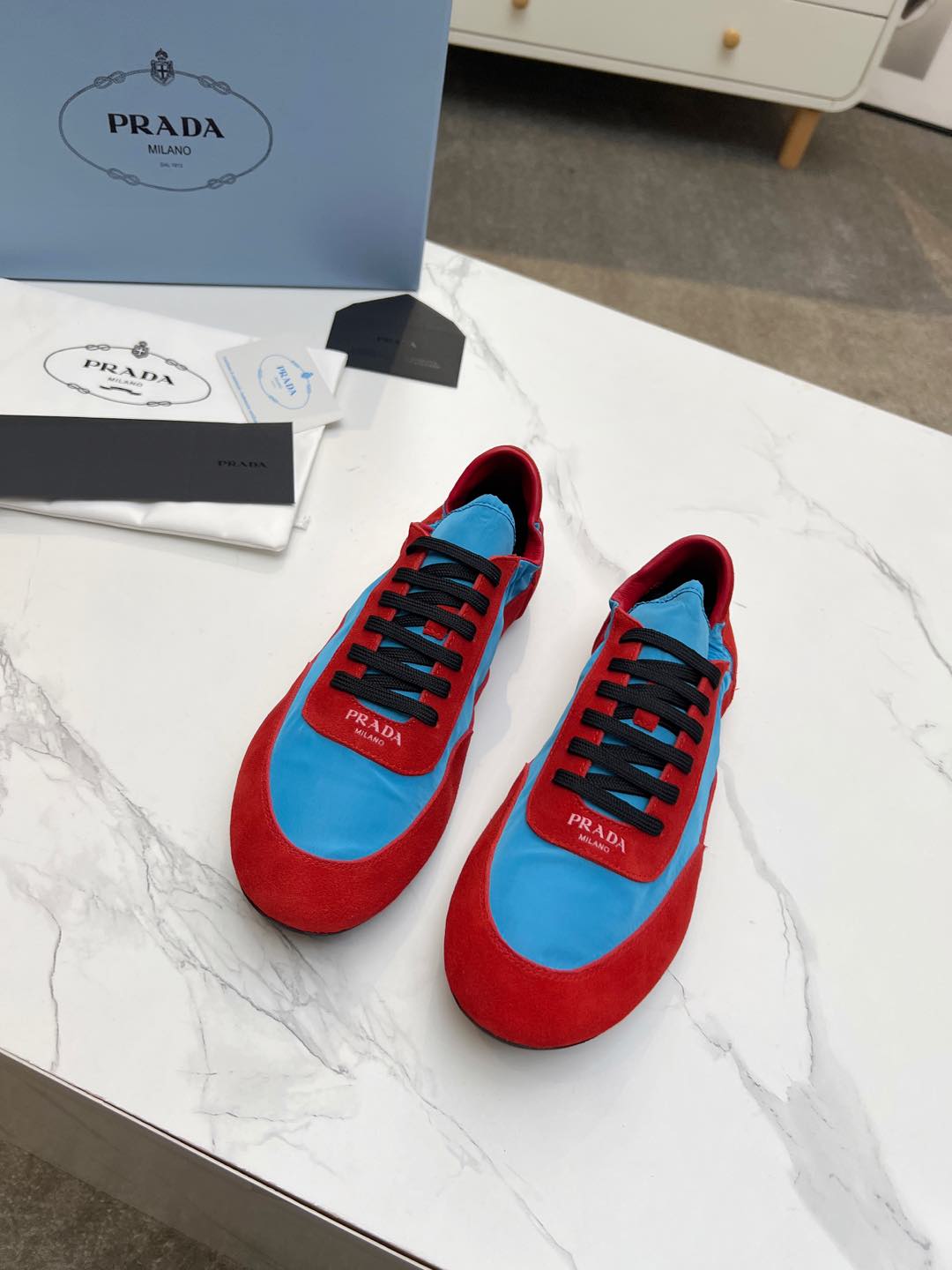 PRADA COLLAPSE SNEAKERS IN RED SUEDE AND SKY BLUE NYLON
