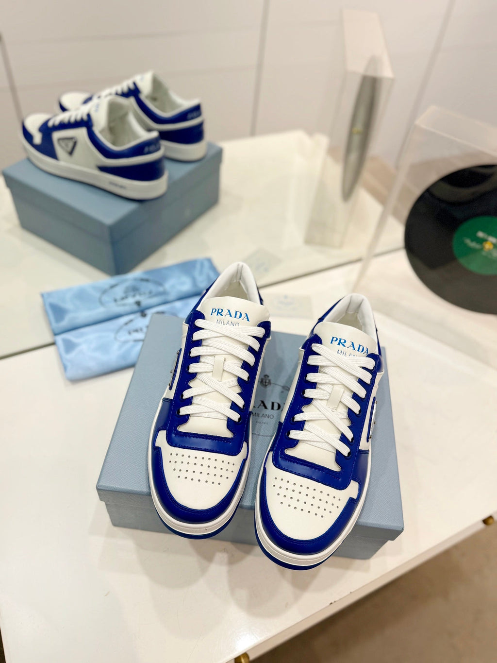 PRADA DOWNTOWN PERFORATED SNEAKERS WHITE AND COBALT CALFSKIN