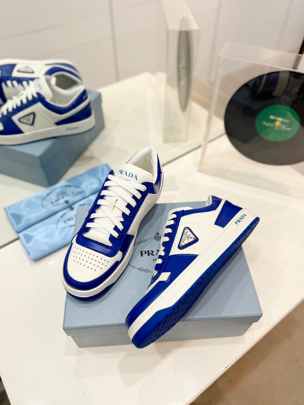 PRADA DOWNTOWN PERFORATED SNEAKERS WHITE AND COBALT CALFSKIN