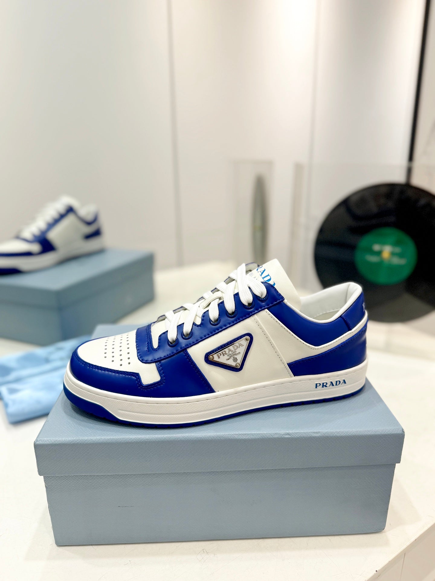 PRADA DOWNTOWN PERFORATED SNEAKERS WHITE AND COBALT CALFSKIN