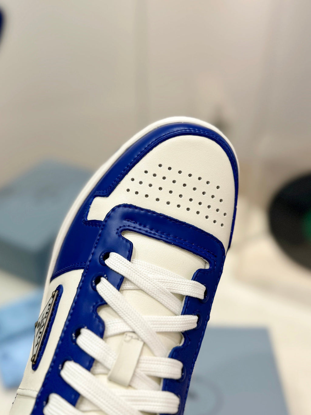 PRADA DOWNTOWN PERFORATED SNEAKERS WHITE AND COBALT CALFSKIN
