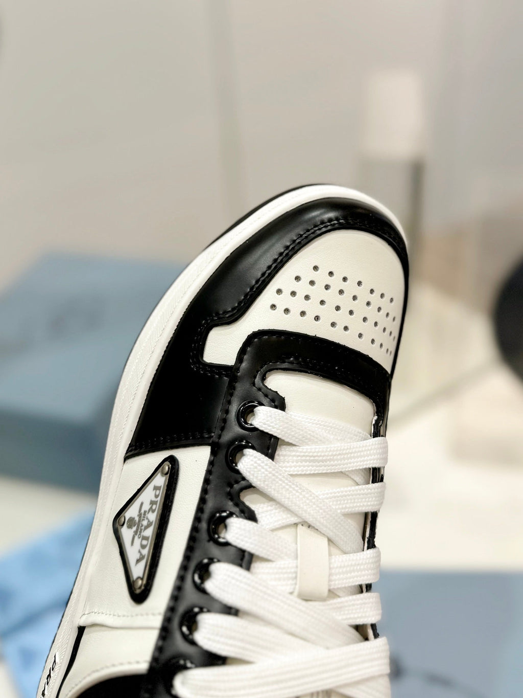 PRADA DOWNTOWN PERFORATED SNEAKERS BLACK AND WHITE CALFSKIN