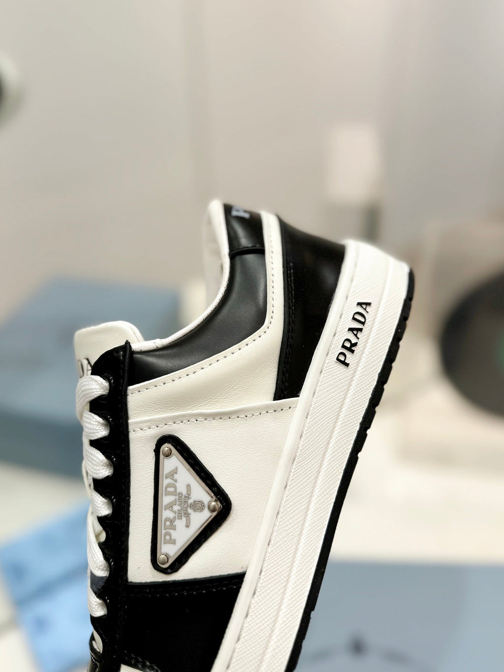 PRADA DOWNTOWN PERFORATED SNEAKERS BLACK AND WHITE CALFSKIN
