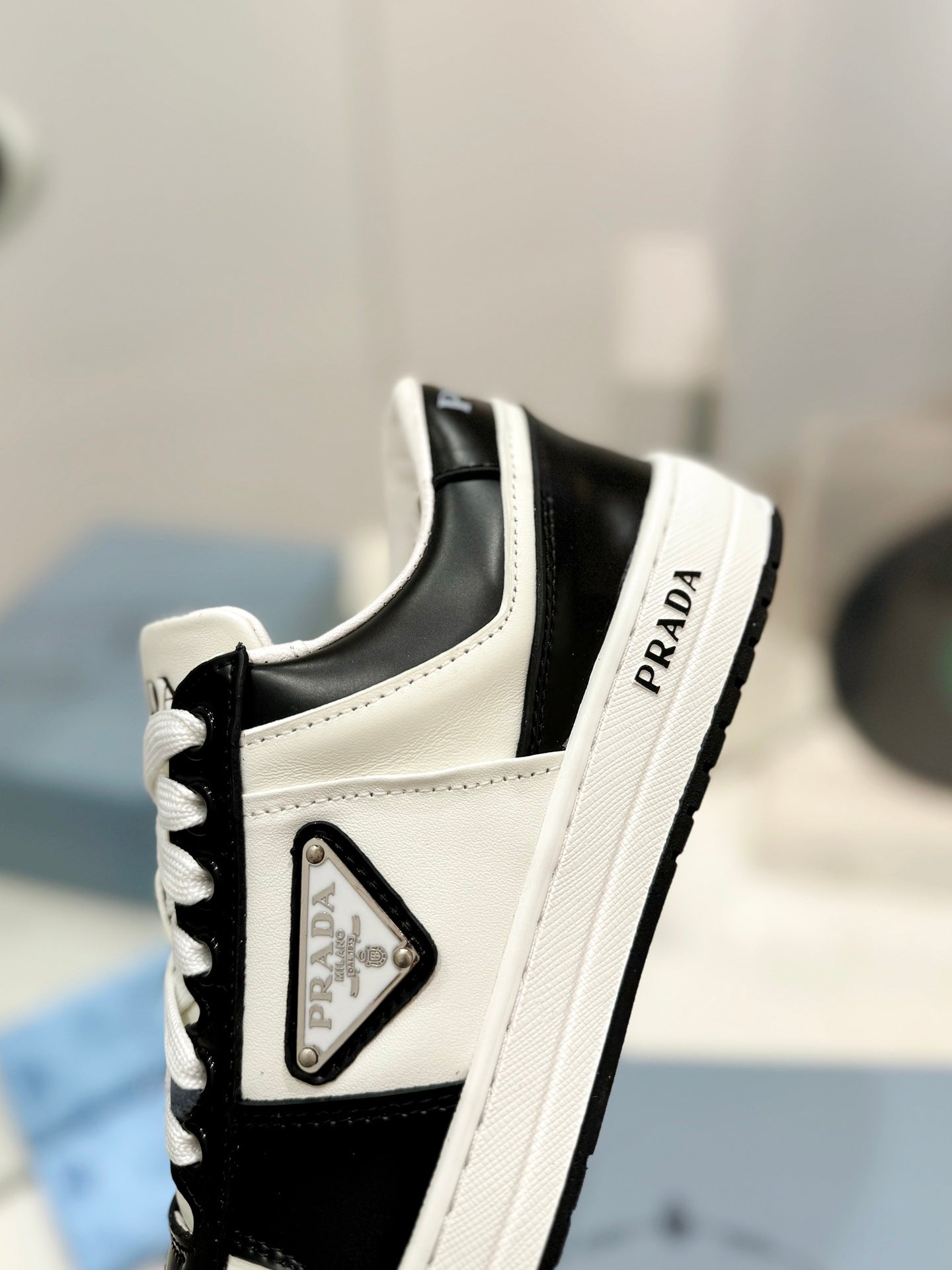 PRADA DOWNTOWN PERFORATED SNEAKERS BLACK AND WHITE CALFSKIN