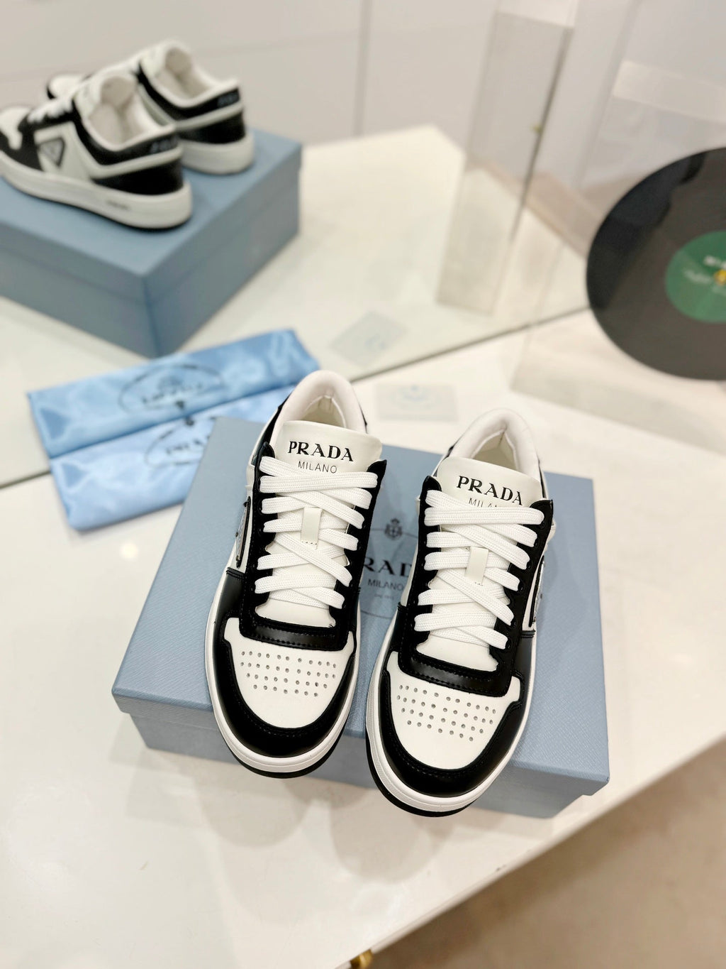 PRADA DOWNTOWN PERFORATED SNEAKERS BLACK AND WHITE CALFSKIN