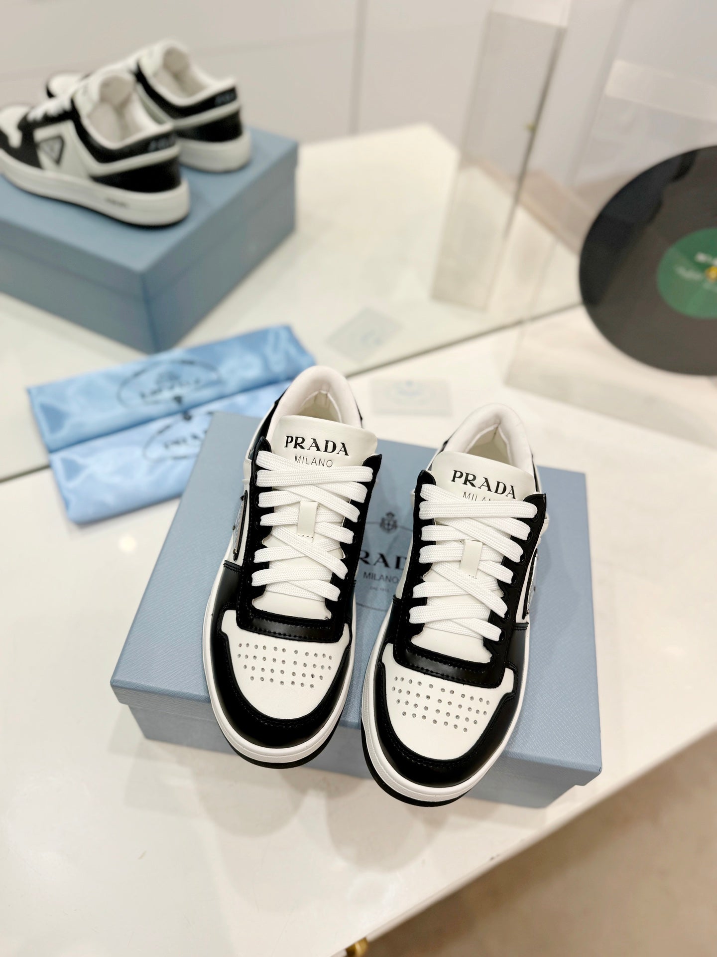PRADA DOWNTOWN PERFORATED SNEAKERS BLACK AND WHITE CALFSKIN