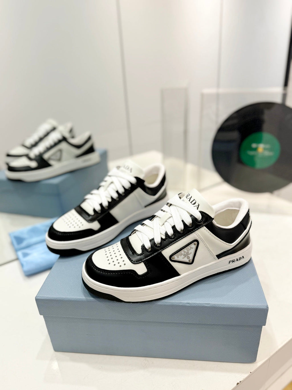 PRADA DOWNTOWN PERFORATED SNEAKERS BLACK AND WHITE CALFSKIN