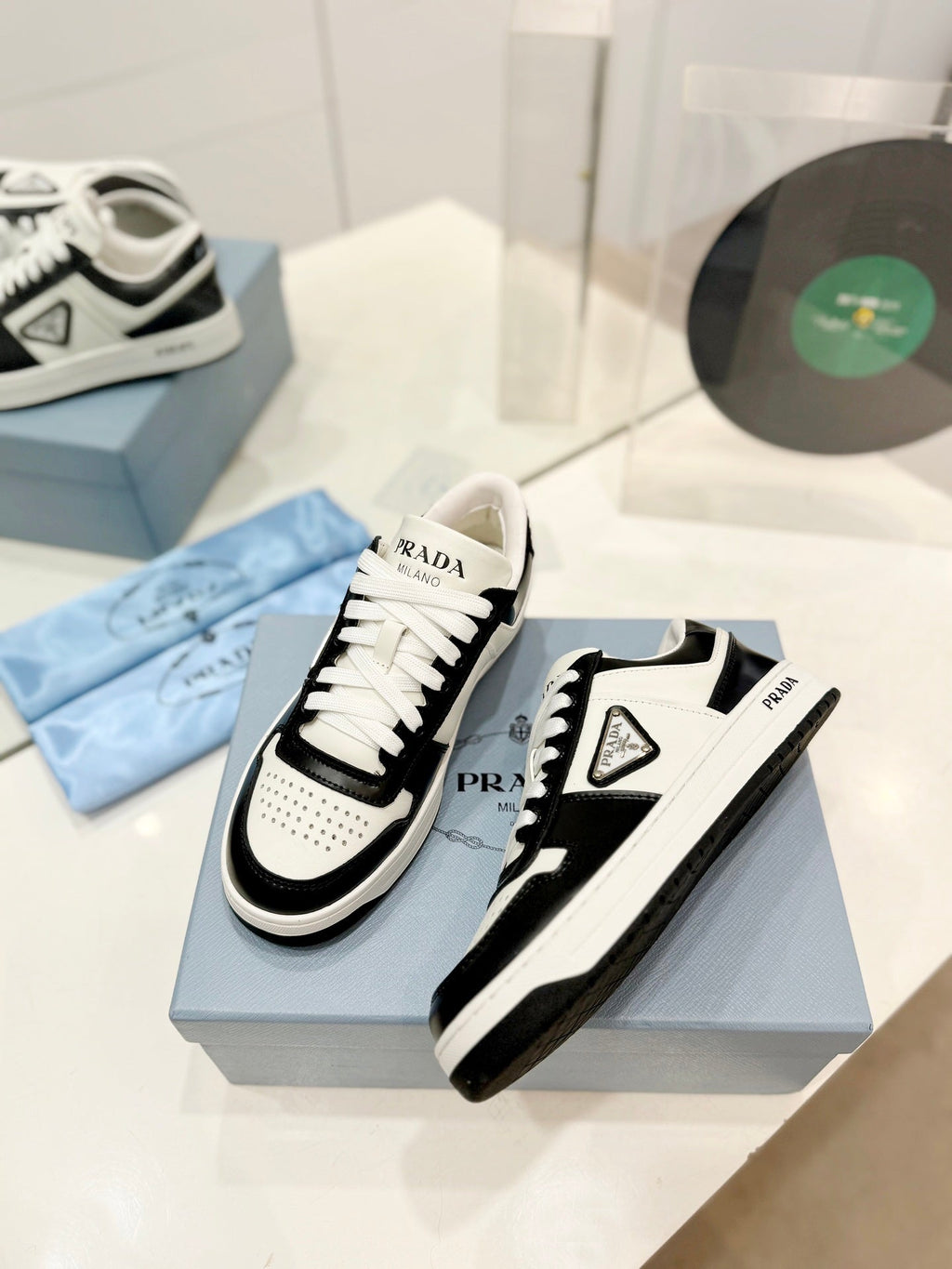 PRADA DOWNTOWN PERFORATED SNEAKERS BLACK AND WHITE CALFSKIN