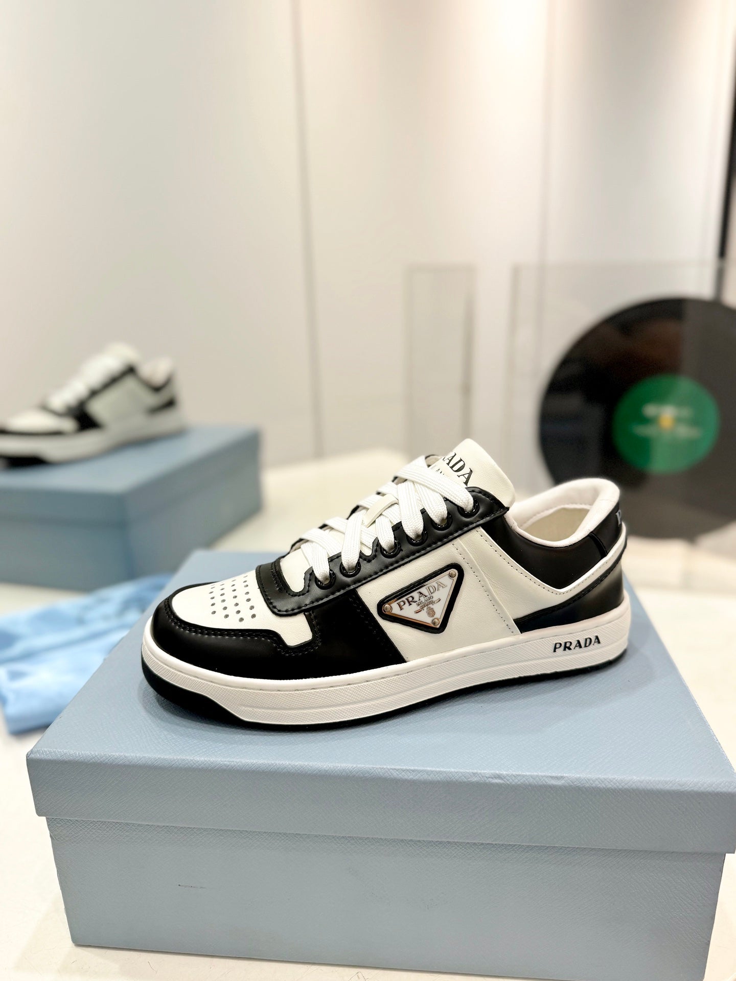 PRADA DOWNTOWN PERFORATED SNEAKERS BLACK AND WHITE CALFSKIN